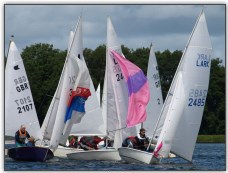 Photo 1. Several boats hoisting spinnakers